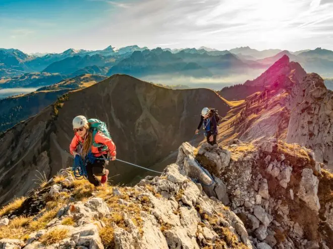 Women climbing a mountain.