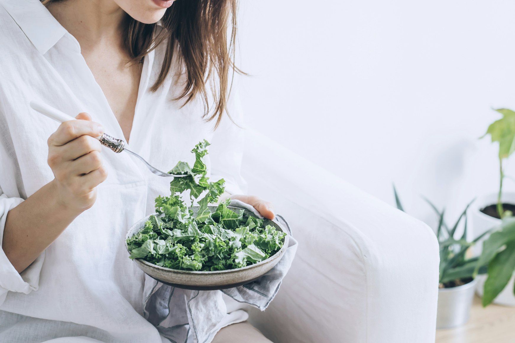 woman eating kale salad